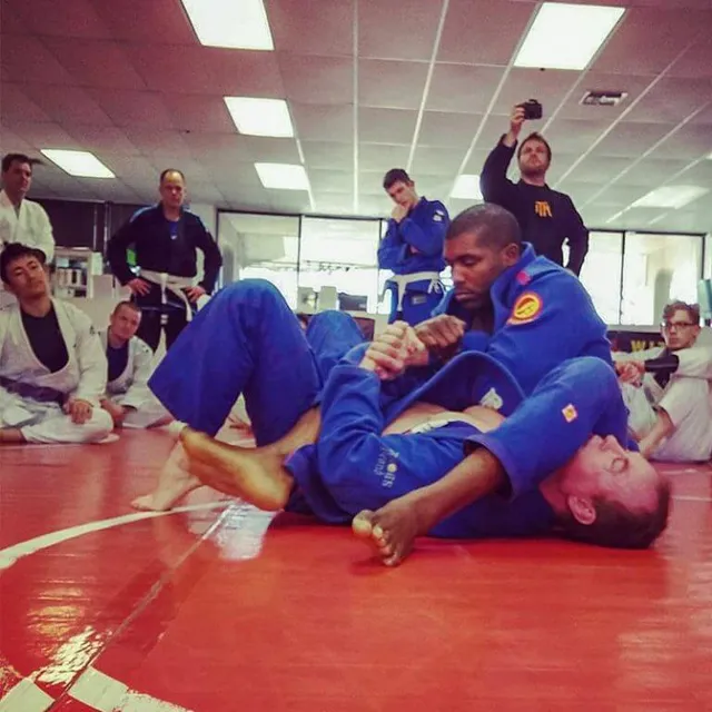 Two students drilling Brazilian Jiu-Jitsu technique in a core fundamentals class at Aces Jiu Jitsu Club